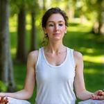 Sara joyfully meditating outdoors, reflecting inner peace and calm.